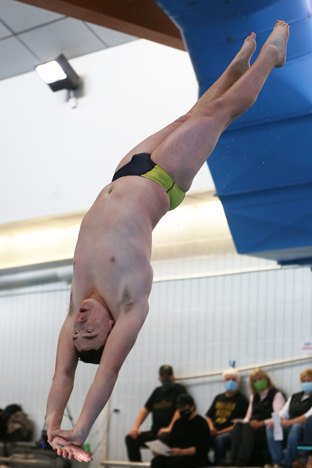 Josiah Bartlett stretches his hands town toward the water during a dive